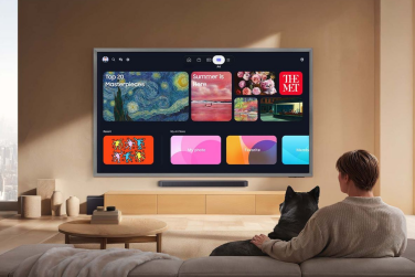 Person and dog watching Samsung S95H TV with apps on screen