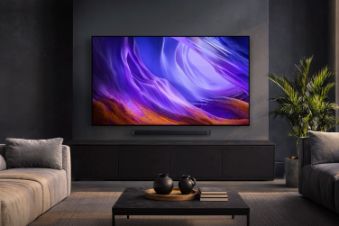 Samsung S90H OLED TV in dark room with purple abstract screensaver