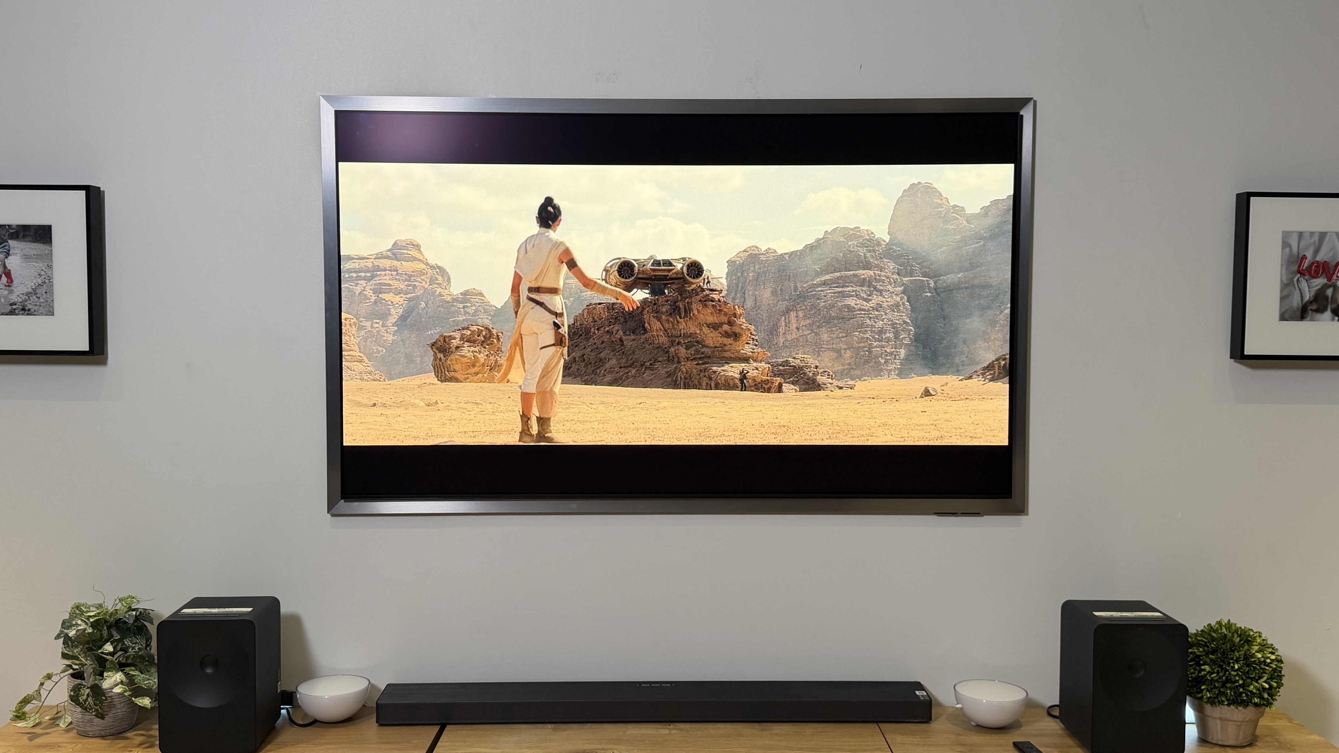 The Samsung S95H OLED TV in a wall-mounted position displaying a scene from "Star Wars: The Rise of Skywalker"