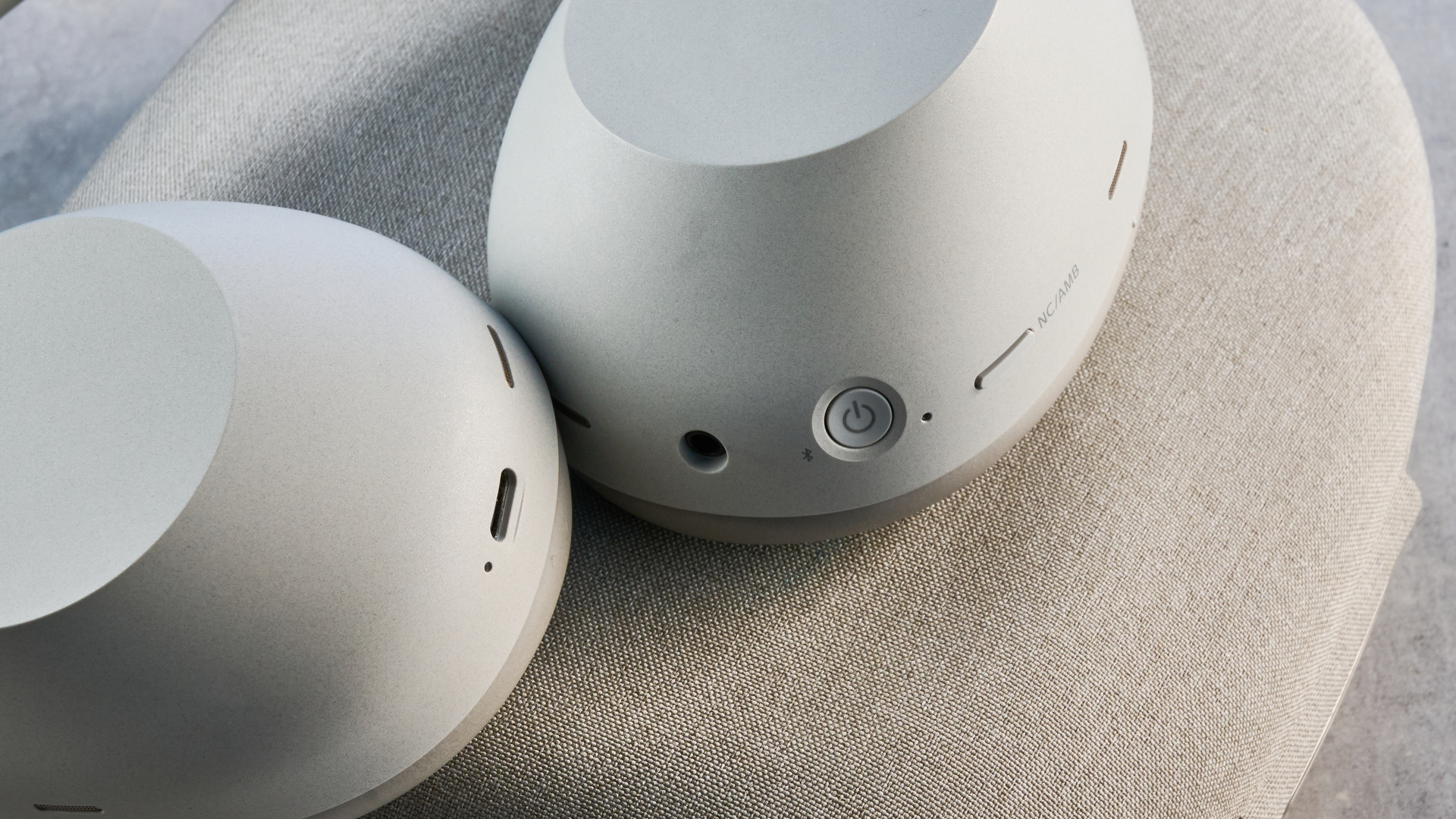 the sony wh-1000xm6 headphones in beige photographed against the blue tom's guide background