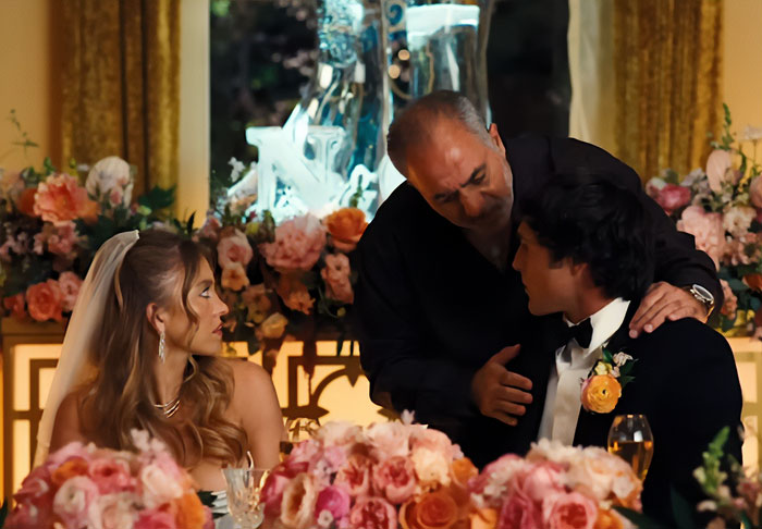 Sydney Sweeney and co-stars dressed elegantly at a flower-adorned event in the new Euphoria season scene.