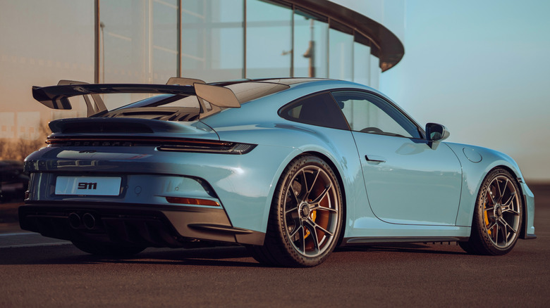 A 992-generation Porsche 911 GT3 parked near a building.