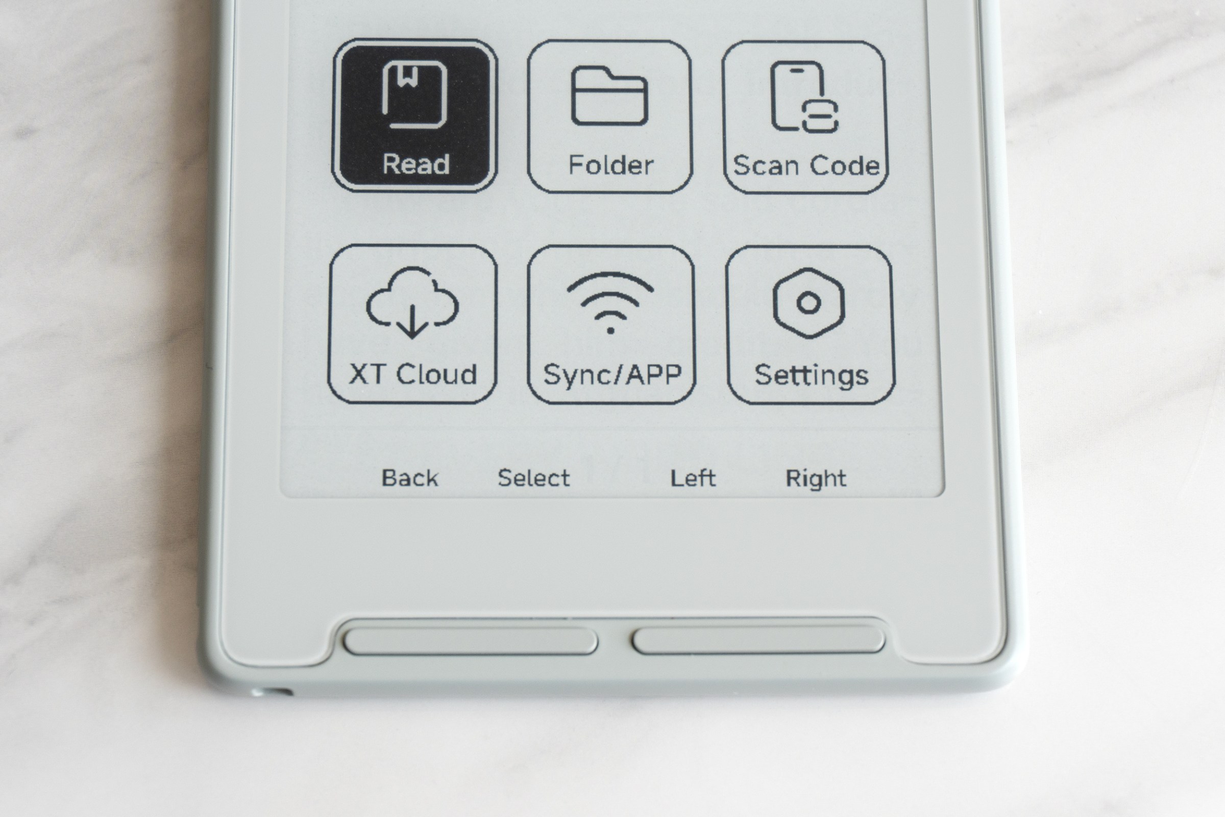 A close-up of the buttons below the Xteink X3 e-reader’s screen.